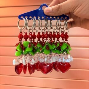 heart-shaped charm with a clear plastic bow at the bottom